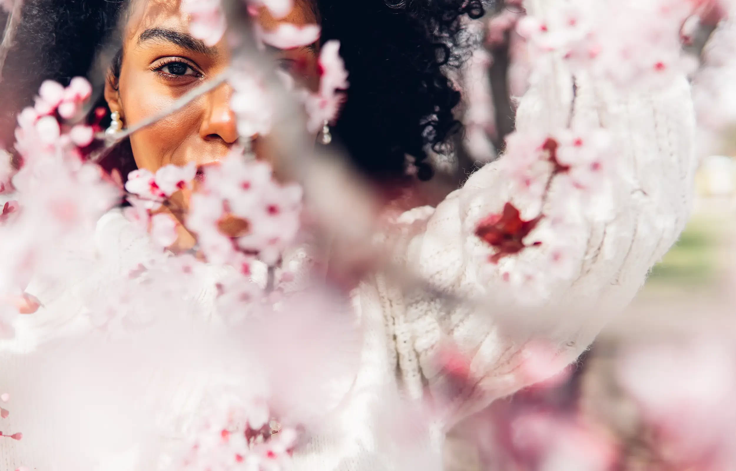 woman-surrounded-by-pink-flowers-in-spring-season-2025-01-09-00-27-34-utc